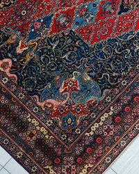 Antique Persian Bakhtiar Rug Circa 1920 | 10' 10" X 14' 1" |  Red & Midnight Blue Colours | Tribal Production